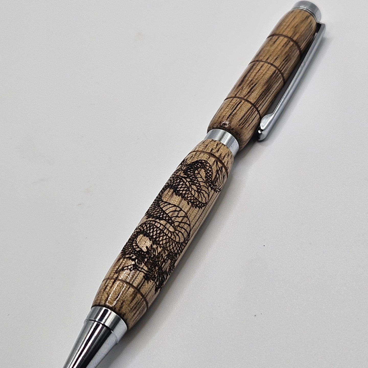 Black limba slimline pen with dragon engraving.