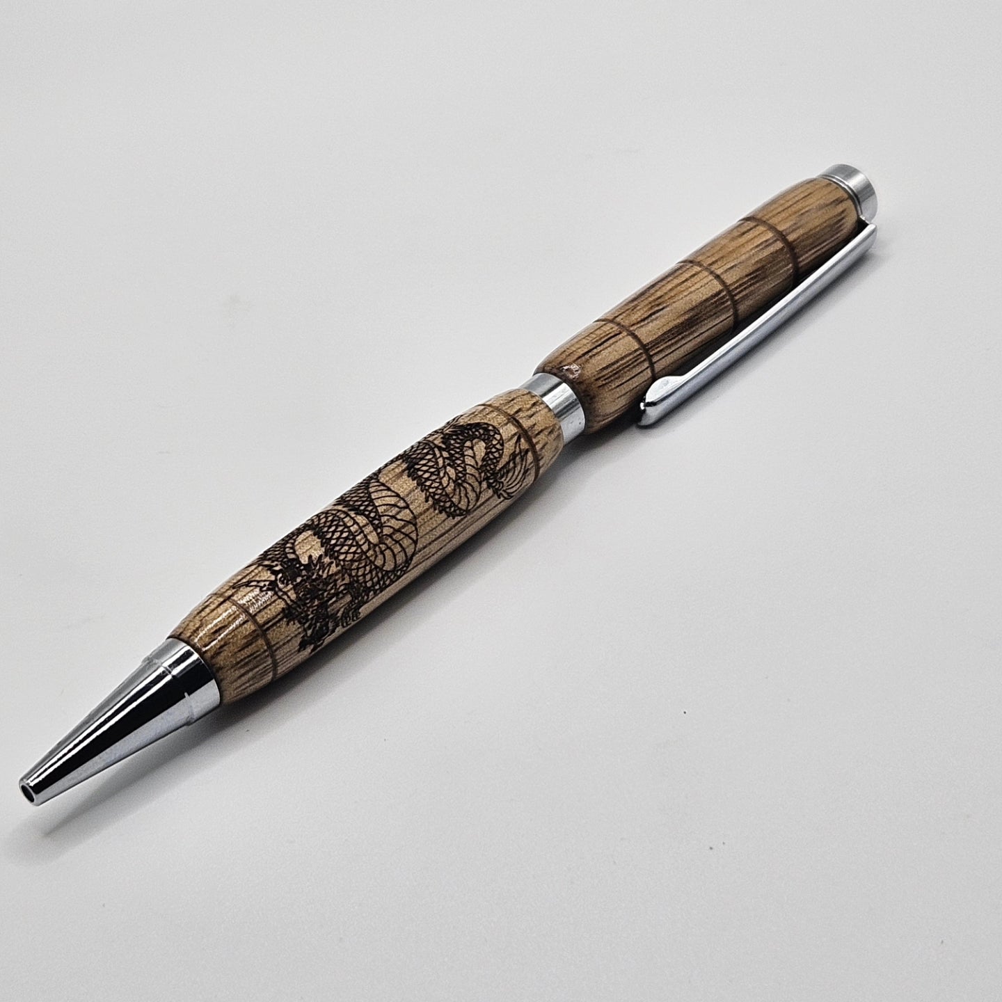 Black limba slimline pen with dragon engraving.