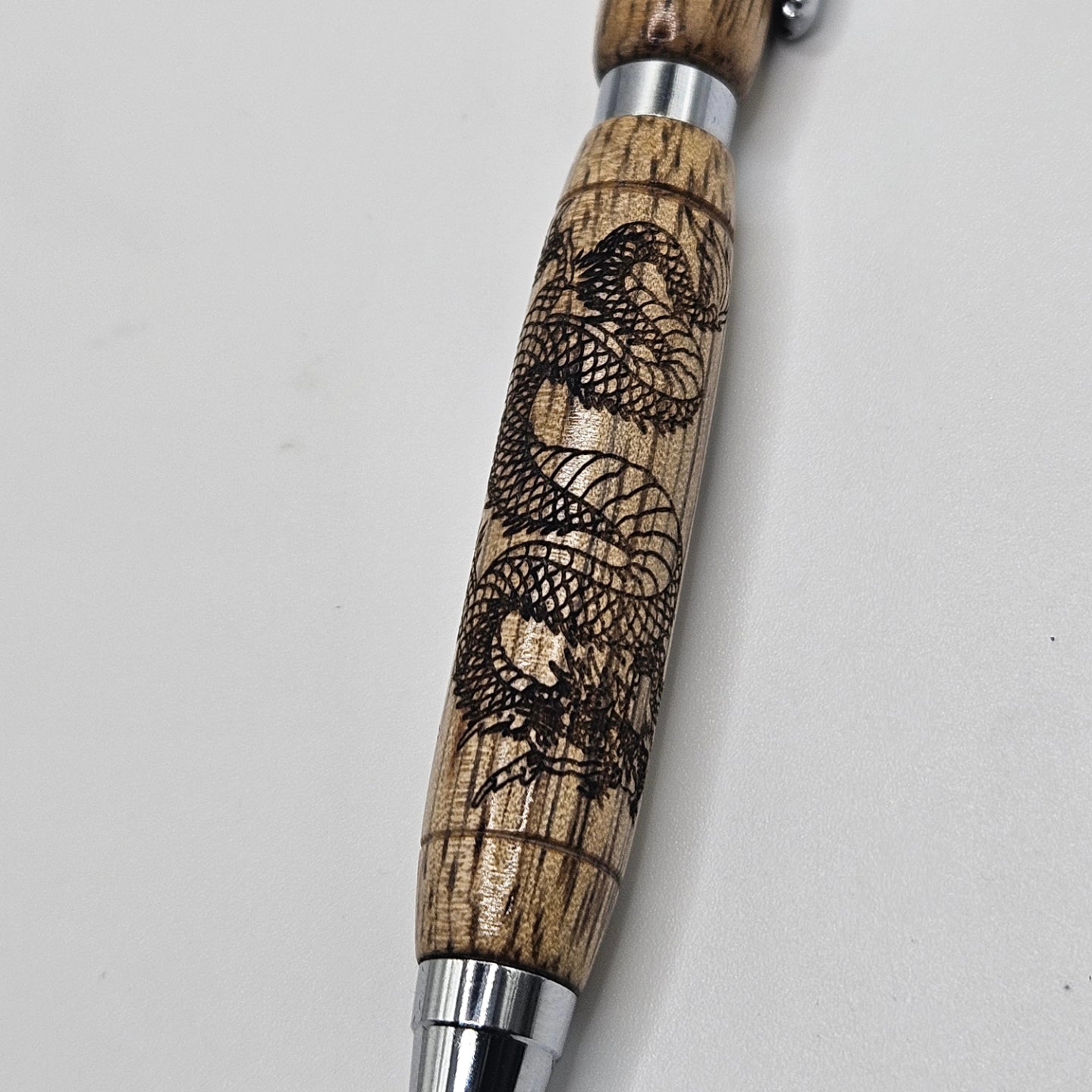 Black limba slimline pen with dragon engraving.